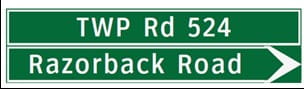 Green sign indicating directions to Razorback Road